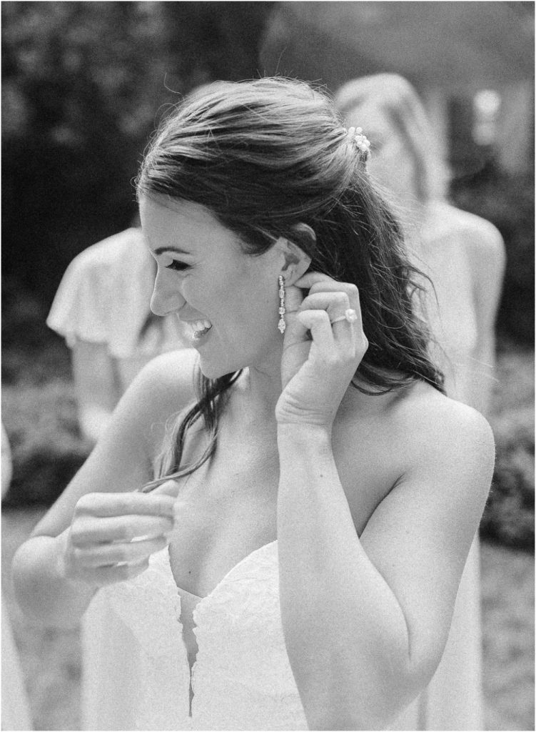 Bride putting on her earrings at her Twenty Mile House wedding