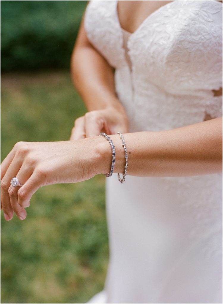 Twenty Mile House Wedding bride putting on her bracelets