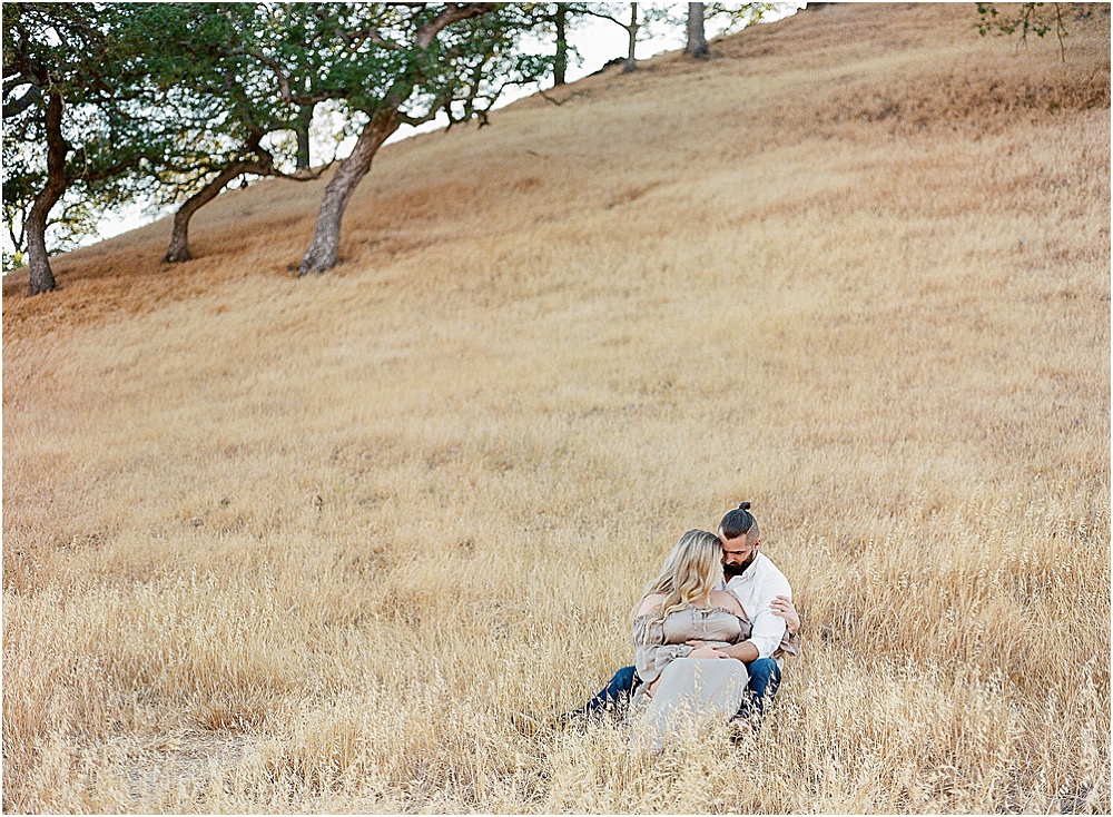 The couple's tenderness shines against the backdrop of a historic barn